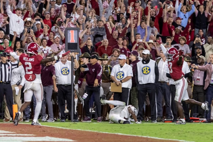 Alabama defensive backs DeMarcco Hellams and Terrion Arnold signal no catch on the final play against Texas A&M.
